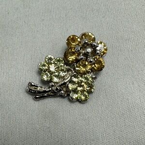 Vintage silver tone flower brooch with pale and dark yellow rhinestones